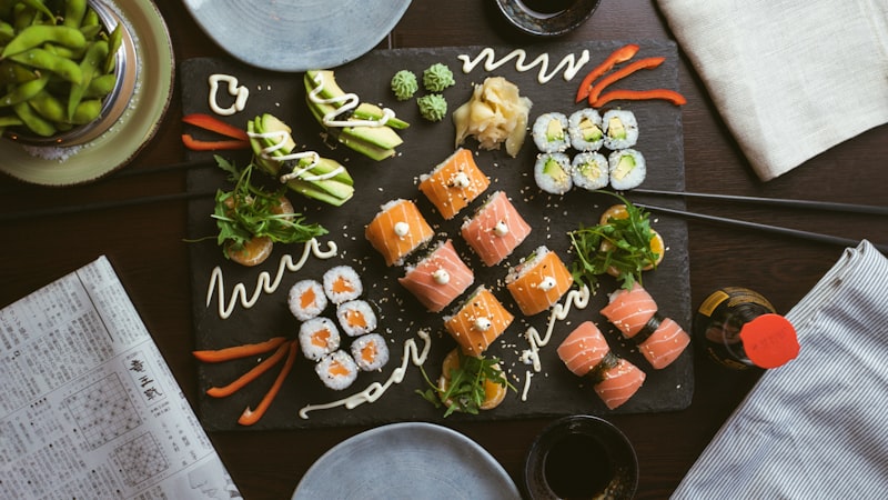 Perfectly formed salmon nigiri sushi on wooden plate